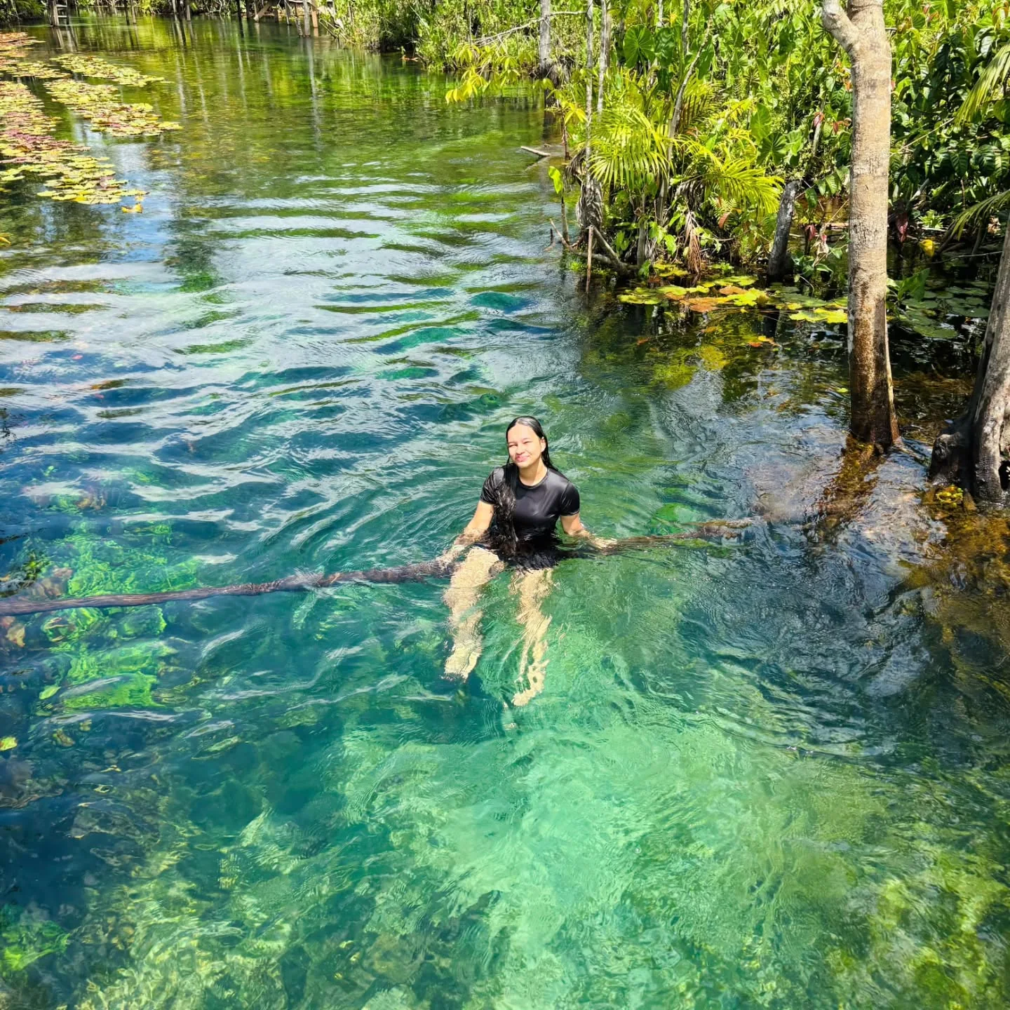 Visitante aproveitando as águas transparentes do Balneário Valentim, entre árvores e vegetação